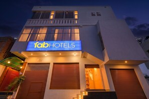 A modern building with a sign for 'fabHOTELS' and a staircase leading to the entrance. - Fabhotel Luxe Cozy (Varanasi)