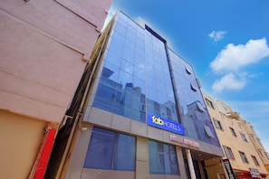 A modern building with a glass facade, a sign for 'Tab Hotels,' and a visible entrance. - Fabhotel Move Inn (Bangalore)
