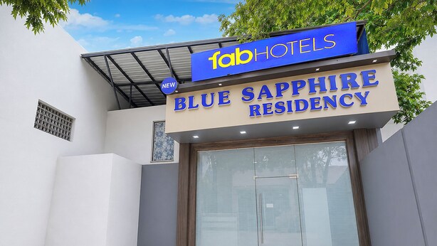 A hotel entrance with a sign for 'Blue Sapphire Residency' and 'FabHotels' above it. - Hotel New Blue Sapphire Residency (Mumbai)