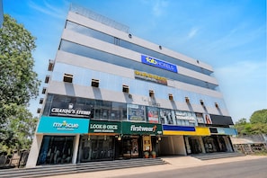 A multi-story building with a sign for 'Shabari Heights Luxury Abode 40 Rooms'.