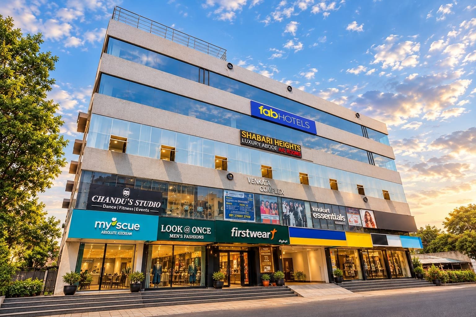 A multi-story hotel with various businesses on the ground floor, including a dance studio, a men's fashion store, and a furniture store.