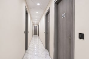 A hallway with doors marked 403, marble flooring, and recessed ceiling lighting. - Fabhotel Shelter Inn (New Delhi)