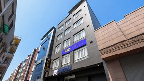 A multi-story hotel with a modern facade, a prominent '1abHOTELS' sign, and a 'HOTEL SKY INN' sign. - Fabhotel Sky Inn (New Delhi)
