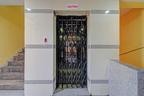 An elevator entrance with a metal gate, a stairway to the left, and a '2nd Floor' sign above. - FabHotel Sri Sai Regency - Nr. RTC X Roads Metro Station (Hyderabad)