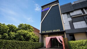 A modern building with a sign for 'The Rolex Grand Hotel' and 'Faber Hotels.' - FabHotel The Rolex Grand - Yatharth Super Speciality Hospital, Sector 20 (Faridabad)