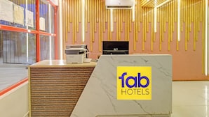A reception desk with a marble top, a fax machine, and an air conditioning unit mounted on the wall. - FabHotel White Ridge Kamineni - Nr. Saroornagar Indoor Stadium- L.B Nagar (Hyderabad)