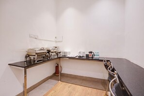 A kitchenette with a stove, toaster, kettle, and a fire extinguisher. - Fabhotel Zillion Executive (Mumbai)