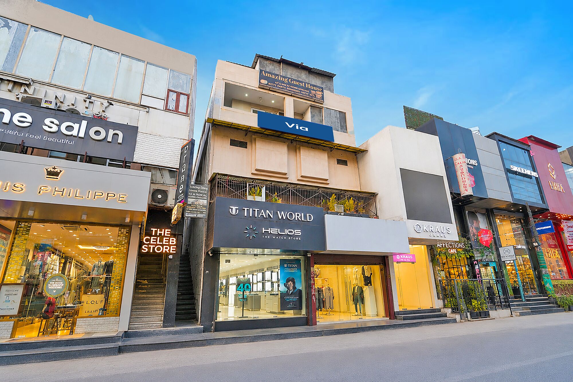 A row of commercial buildings with various storefronts, including a salon, a watch store, and a clothing store.