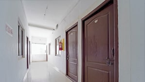 A corridor with doors numbered 107 and 106, white walls, and a tiled floor. - Via Zane - Nr Coimbatore International Airport (Coimbatore)