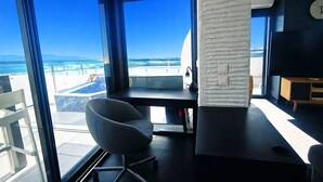 A modern room with a large window, a desk, a chair, and a television. - apartment with terrace in Saint-Cyprien (Saint-Cyprien)