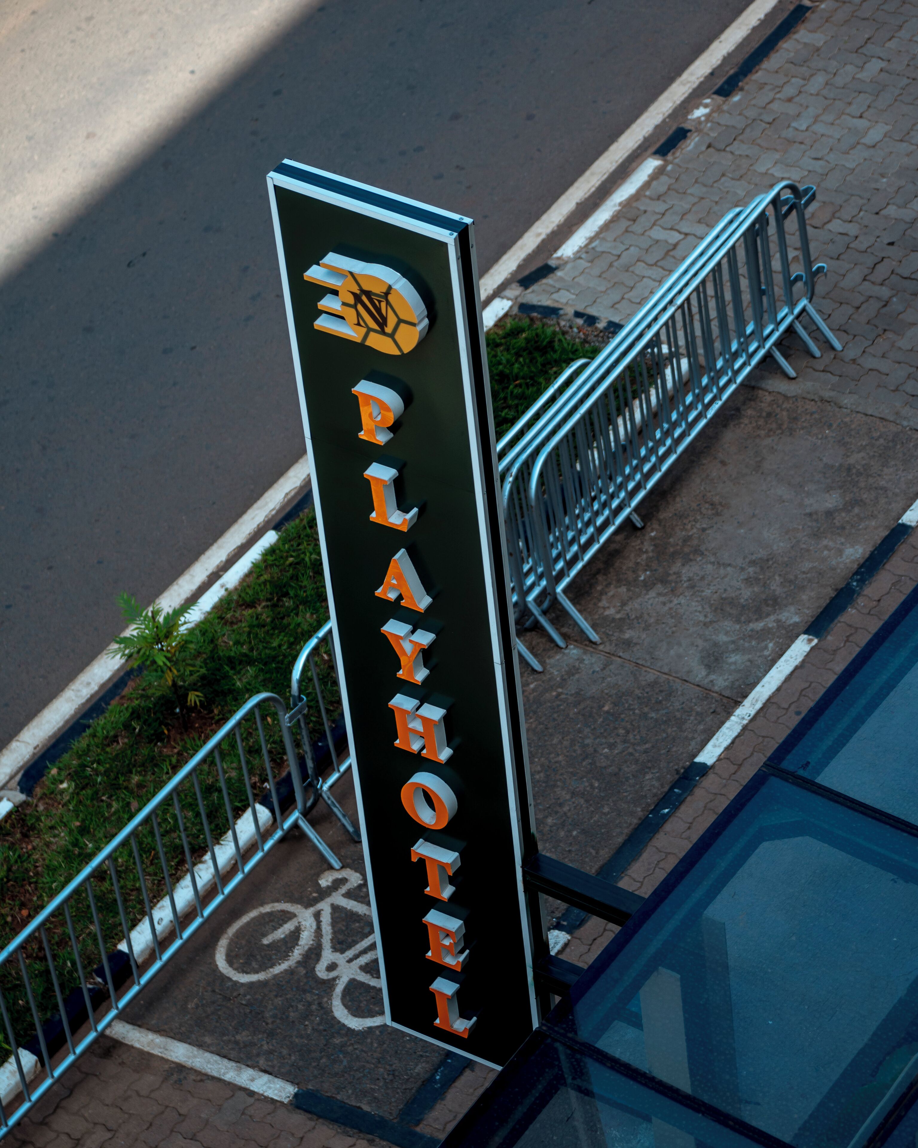 A vertical sign with the text 'PLAYHOTEL' indicating the name of the establishment.