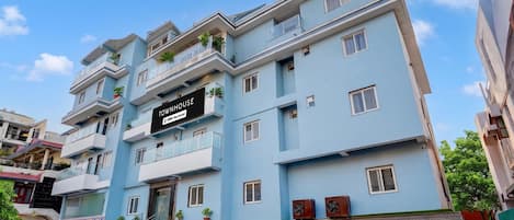 A multi-story building with a sign indicating it is a townhouse.