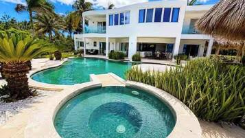 A modern two-story building with a swimming pool in the foreground.