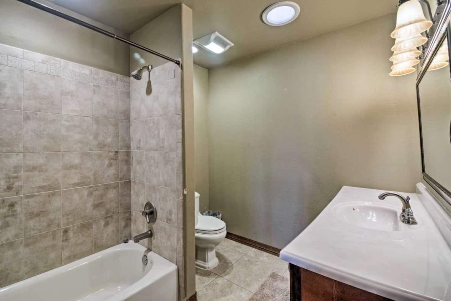A bathroom with a bathtub, a toilet, and a sink.