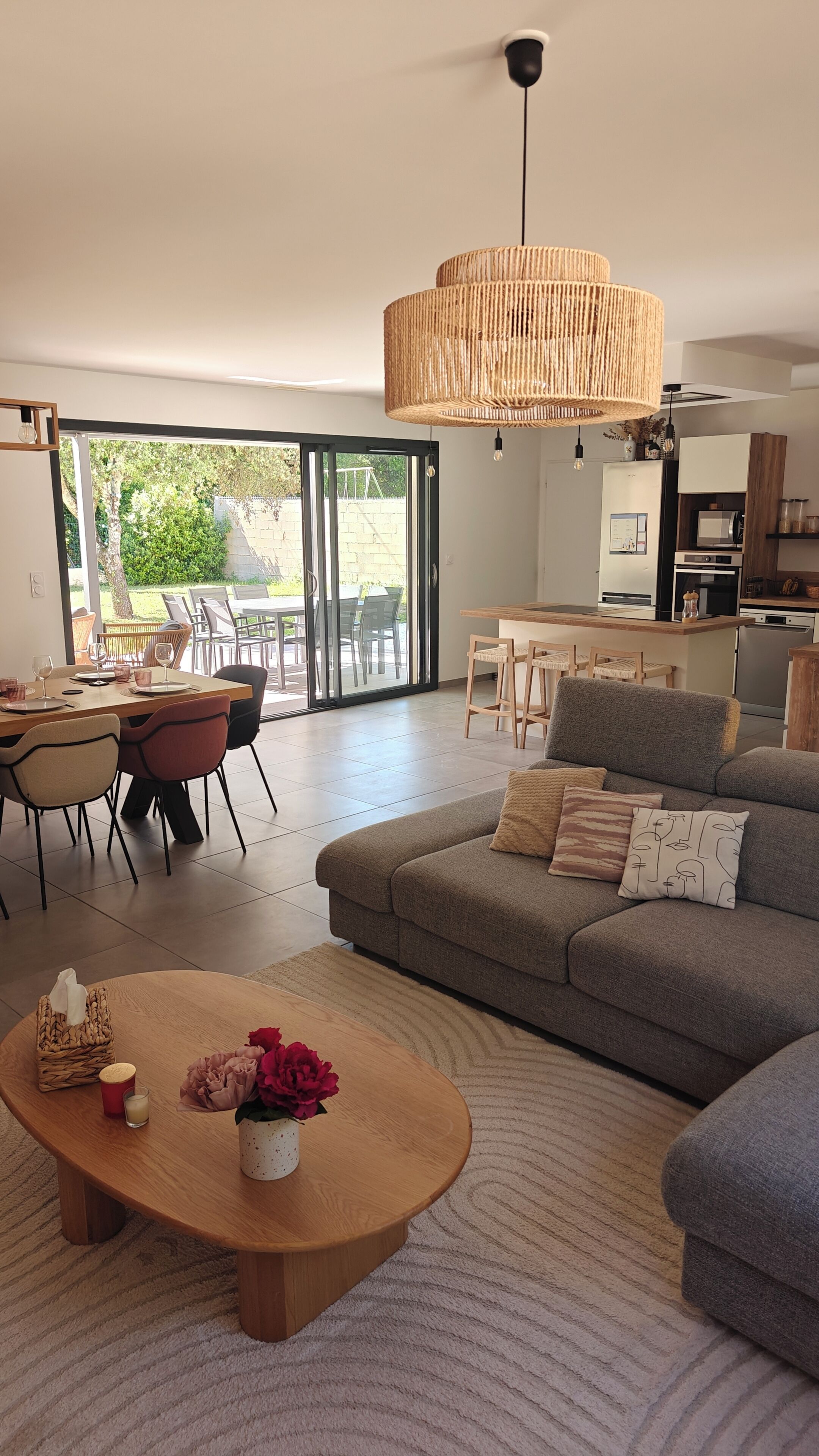 A modern living room with a sofa, coffee table, and dining area.