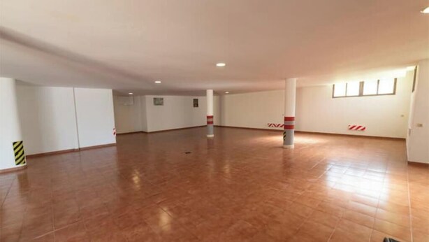 A spacious, empty room with a tiled floor, white walls, and a ceiling with recessed lighting. - Luxury beachfront villa in Marbella (Marbella)