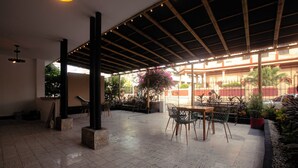 An indoor patio area with a tiled floor, a wooden pergola, and outdoor seating. - Casa Santa Cruz | Private Jacuzzi | 6 Suites | 16+ (Cartagena de Indias)