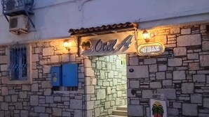 Un edificio de piedra con un letrero que dice 'Otel A' y un letrero que indica '#1 BAR' sobre la entrada.
