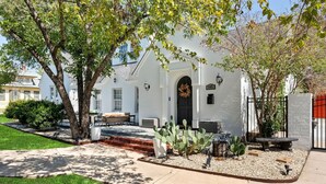 A white house with a black door, a porch, and a number '145' sign. - Venue 1925 with pool (Belton)
