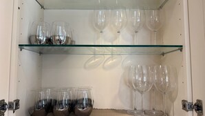 A storage unit with shelves containing wine glasses and a basket. - Huntington Beach 2bed/2bath house.| Near Beach, Dining, Family Fun & Relaxation (Huntington Beach)