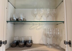 A storage unit with shelves containing wine glasses and a basket. - Huntington Beach 2bed/2bath house.| Near Beach, Dining, Family Fun & Relaxation (Huntington Beach)