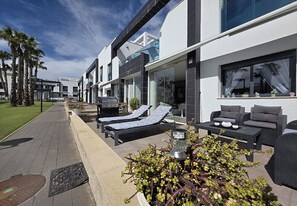 Ein modernes Hotel mit Außenbereich, einem Weg und einem gepflegten Garten.