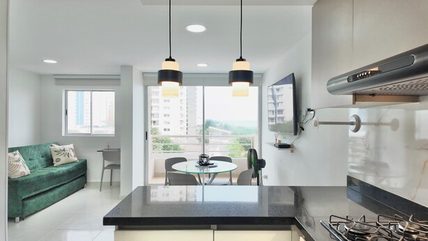 A modern kitchen with a central island, pendant lighting, and a view of the city. - Cozy apartment, location to enjoy the beautiful Cartagena/Colombia. (Cartagena de Indias)