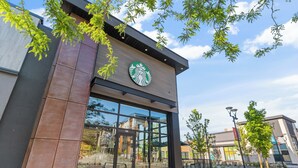 A Starbucks store with a large glass window, a modern design, and a clear sky. - Upper Mission Casita | Boutique Lakeview Suite for Business or Leisure (Kelowna)