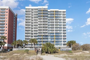 A multi-story hotel with balconies, a pool area, and a beach view. - TOP Floor 2bd/2ba Oceanfront Master w Free Wi-fi (Myrtle Beach)