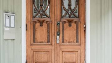 A double wooden door with glass panels and a metal handle.