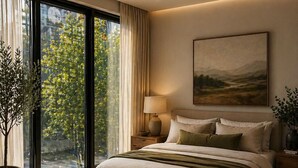 A bedroom with a large bed, a nightstand, a lamp, a window with curtains, a potted plant, and a painting on the wall. - Maison Menos Private Suite A- 1 Bedroom with 1 private Bathroom (Hoboken)
