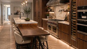 A modern kitchen with a central island, wooden cabinetry, and stainless steel appliances. - Maison Menos Private Suite A- 1 Bedroom with 1 private Bathroom (Hoboken)
