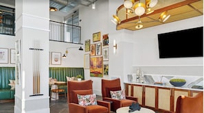 A modern interior with a dining area, seating, artwork, and a TV. - Landing | Spectacular 1BD, Gym, Clubhouse (Brentwood)