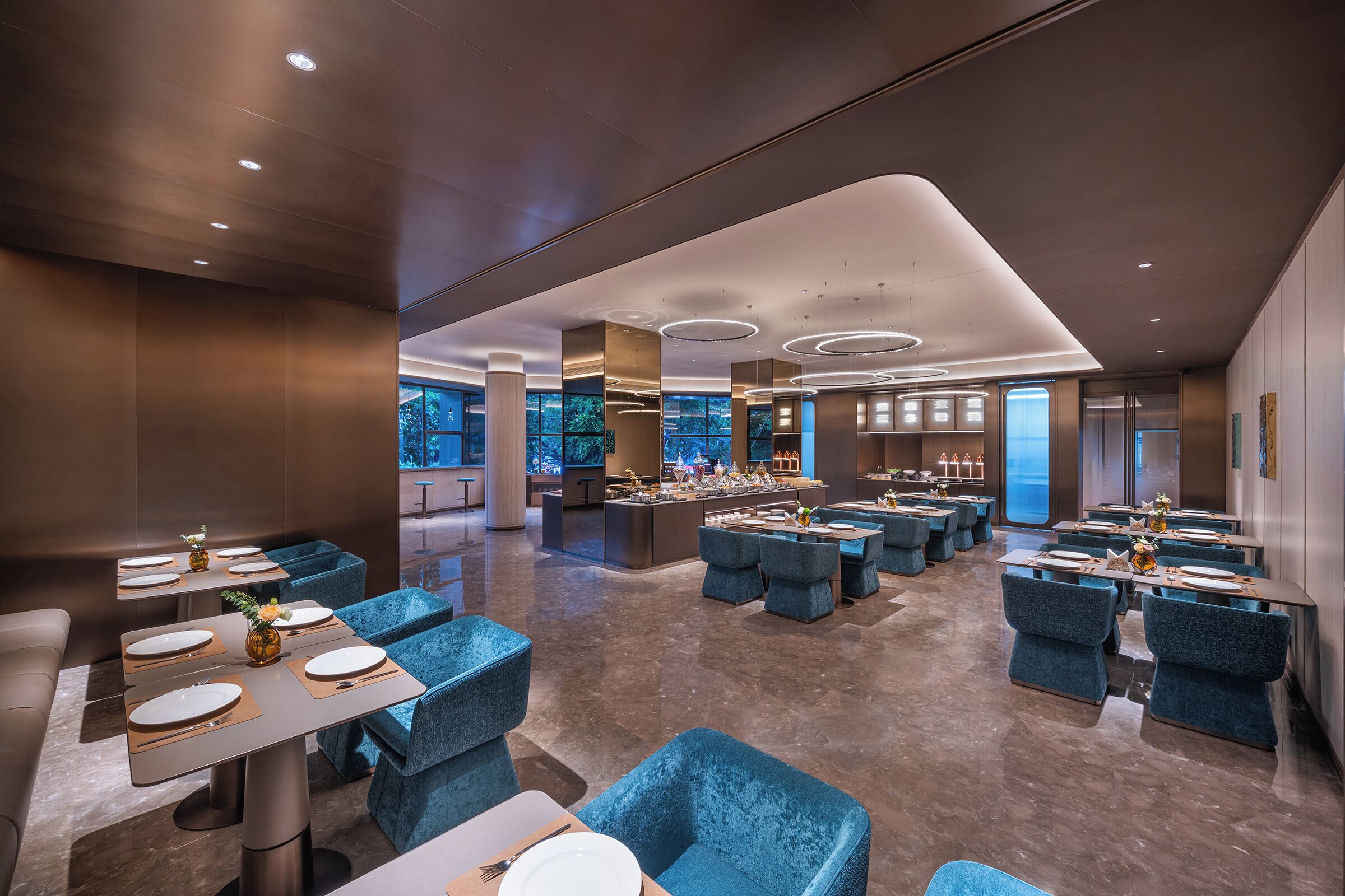 A modern dining area with tables, chairs, and a bar.