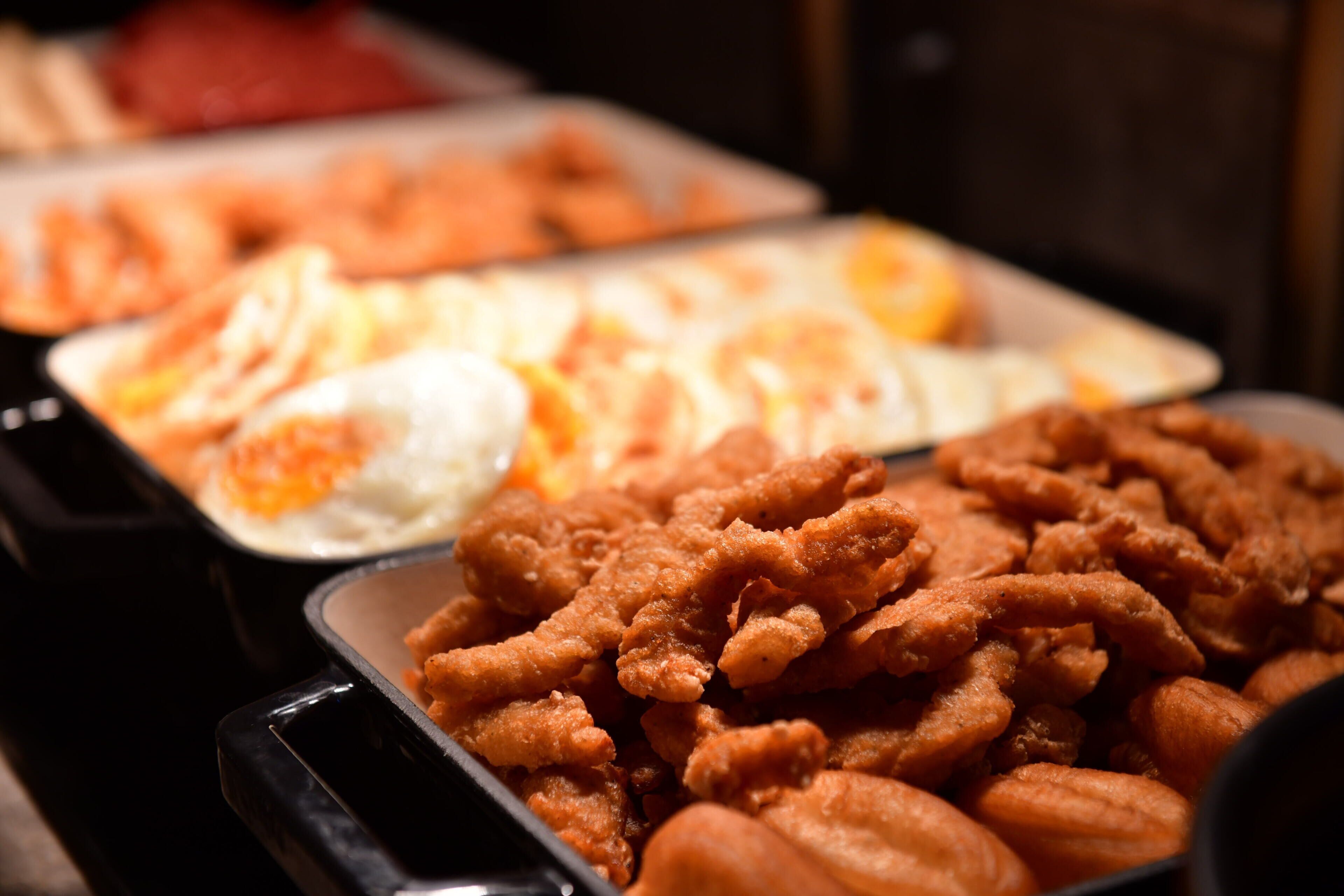 A buffet with various food items including fried chicken and other dishes.