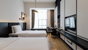 A hotel room with two beds, a desk, a TV, and a window with curtains. - Orange Crystal Hongyadong Hotel (Chongqing)
