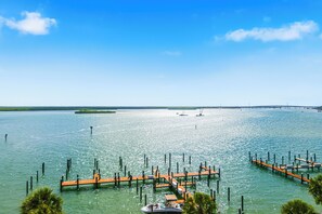 A marina with wooden docks extending into calm water, surrounded by greenery. - Top Floor Marco Island Waterfront Condo with heated pool (Marco Island)