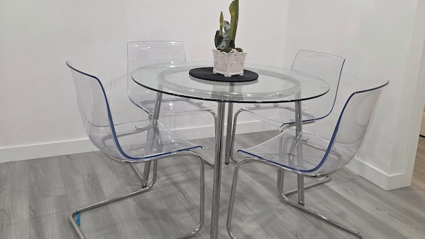 A modern dining area with a glass table, clear chairs, and a potted plant. - 3 mins to Henday ,16 mins to WEM
1 cozy bedroom in a quite neighborhood.
No Pets (Edmonton)