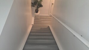 A staircase with a handrail, a potted plant, and a door at the top. - 3 mins to Henday ,16 mins to WEM
1 cozy bedroom in a quite neighborhood.
No Pets (Edmonton)