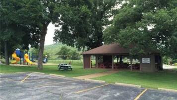 A park with a pavilion, picnic tables, and a playground.