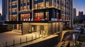 A modern hotel with a glass facade, a prominent entrance, and a rooftop terrace. - Intercity Hotel Guanyinqiao Chongqing (Chongqing)