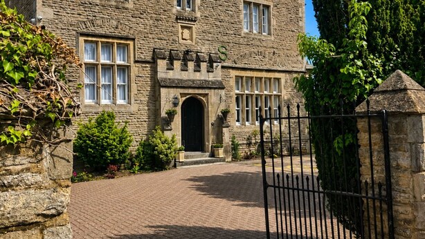 A stone building with a symmetrical facade, a central entrance, and a gated driveway. - Belvilla at Brackley, near Silverstone Circuit (Brackley)