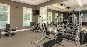 A gym with exercise equipment, mirrors, and windows. - Landing | Chic 1BD, Gym, Clubhouse (Apopka)