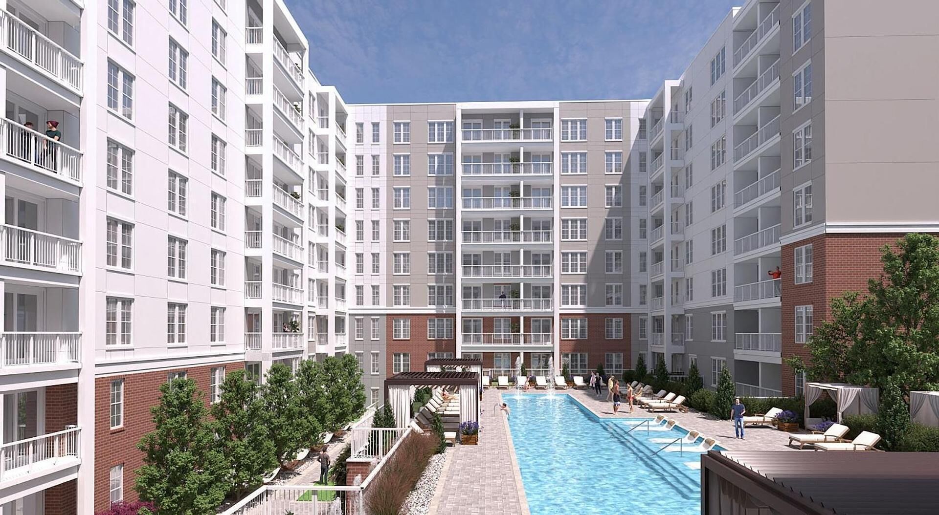 Un immeuble résidentiel à plusieurs étages doté de balcons, d’une piscine et d’espaces de détente.