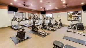 A gym with treadmills, elliptical machines, and stationary bikes arranged in rows. - Landing | Spectacular 3BD, Game Room, Clubhouse (Gulf Hills)
