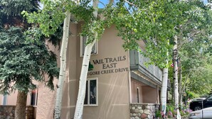 A building with a sign reading 'Vail Trails East 3 Gore Creek Drive.' - Vail Trails East 5B, 1BD Condo on East Side of Vail Village (Vail)