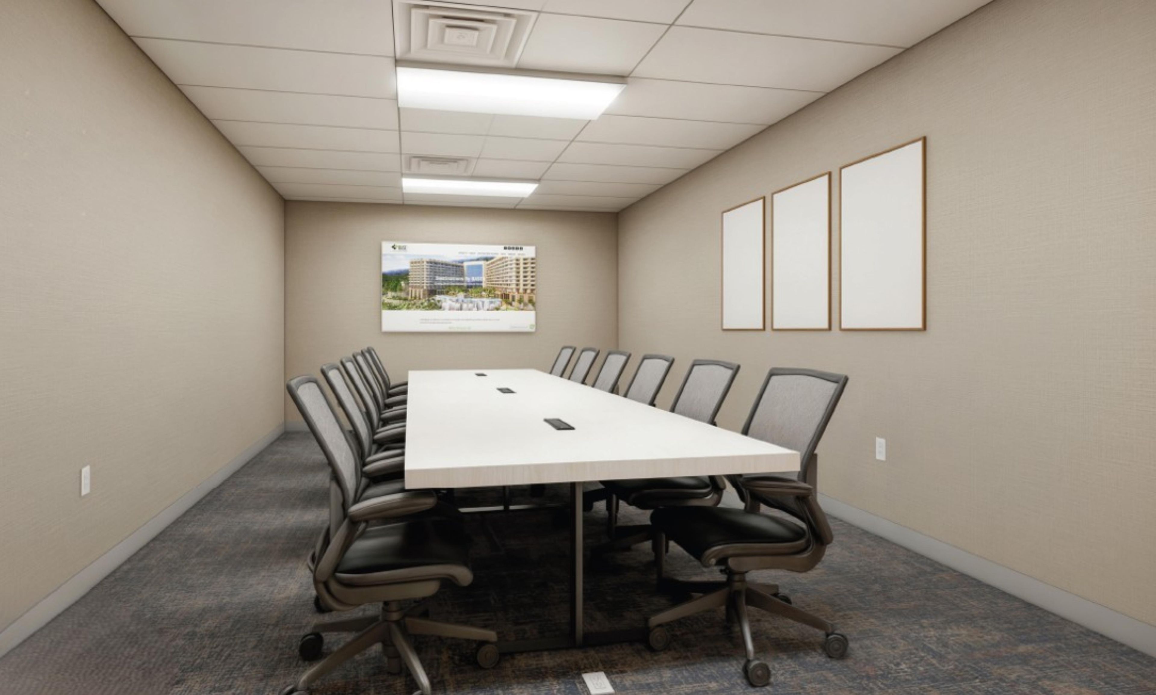 Une salle de conférence avec une longue table, des chaises, un sol recouvert de moquette, un tableau encadré au mur et un plafond doté d’un éclairage encastré.