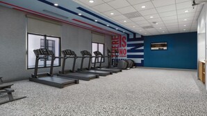 A gym with treadmills, a wall with motivational text, and a blue accent wall. - Hampton Inn By Hilton Manhattan Aggieville (Manhattan)
