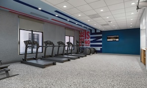 A gym with treadmills, a wall with motivational text, and a blue accent wall. - Hampton Inn By Hilton Manhattan Aggieville (Manhattan)