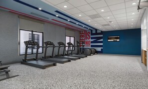 A gym with treadmills, a wall with motivational text, and a blue accent wall. - Hampton Inn By Hilton Manhattan Aggieville (Manhattan)